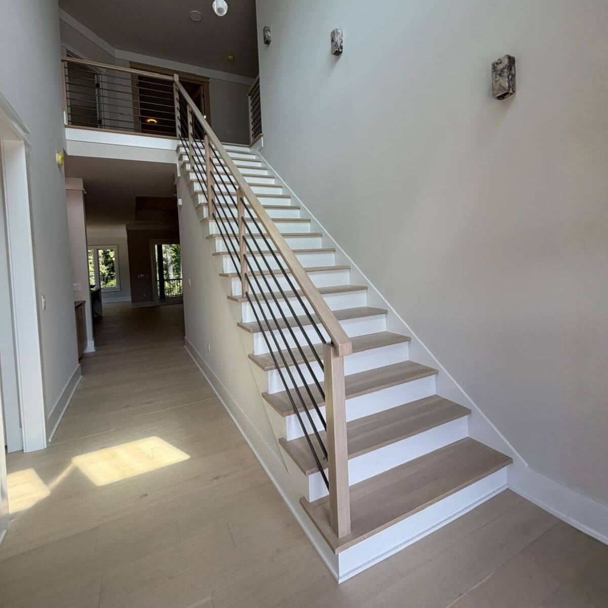 Straight stairs with horizontal metal railing in Durham, NC